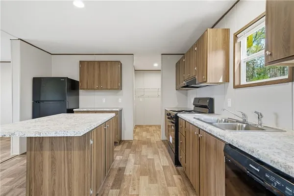a kitchen with a sink stove and refrigerator