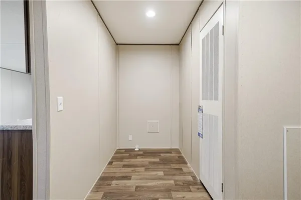 a view of a hallway with wooden floor and entryway