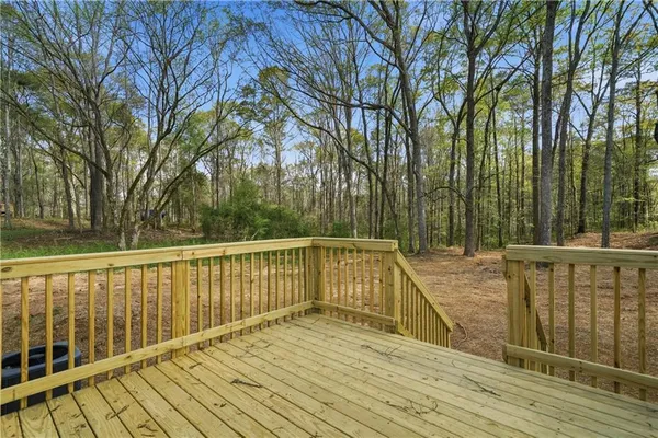 a view of balcony with wooden floor and fence