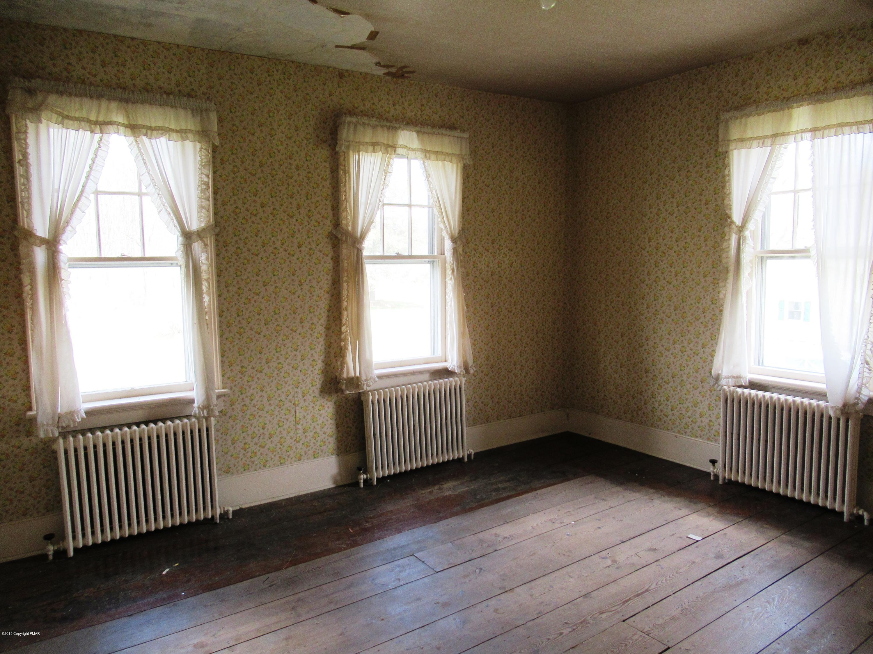 443 Bossardsville Road Stroudsburg, PA 18360 - Photo 25 of 43 an empty room with wooden floor and windows