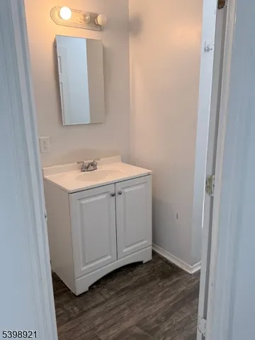 a bathroom with a sink a mirror and vanity