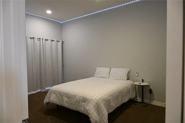 a bedroom with a bed and a view of closet