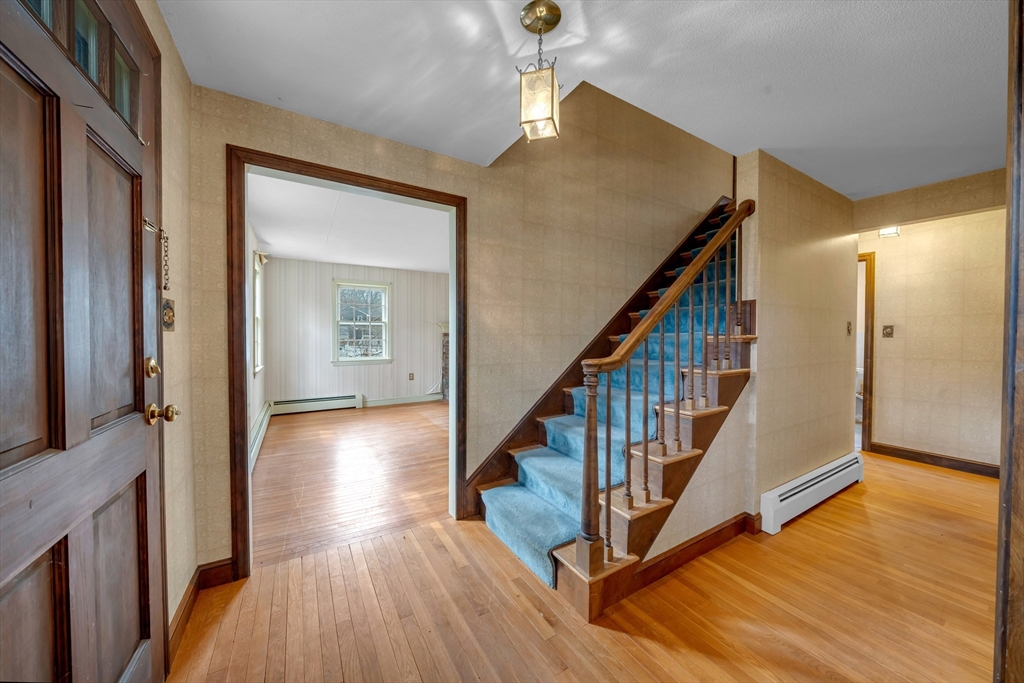 449 Summer Street North Andover, MA 01845 - Photo 12 of 26 a view of a hallway with wooden floor and staircase