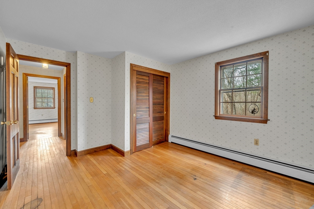 449 Summer Street North Andover, MA 01845 - Photo 18 of 26 a view of an empty room with wooden floor and a window