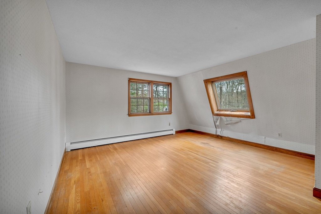 449 Summer Street North Andover, MA 01845 - Photo 19 of 26 a view of an empty room with a window and wooden floor
