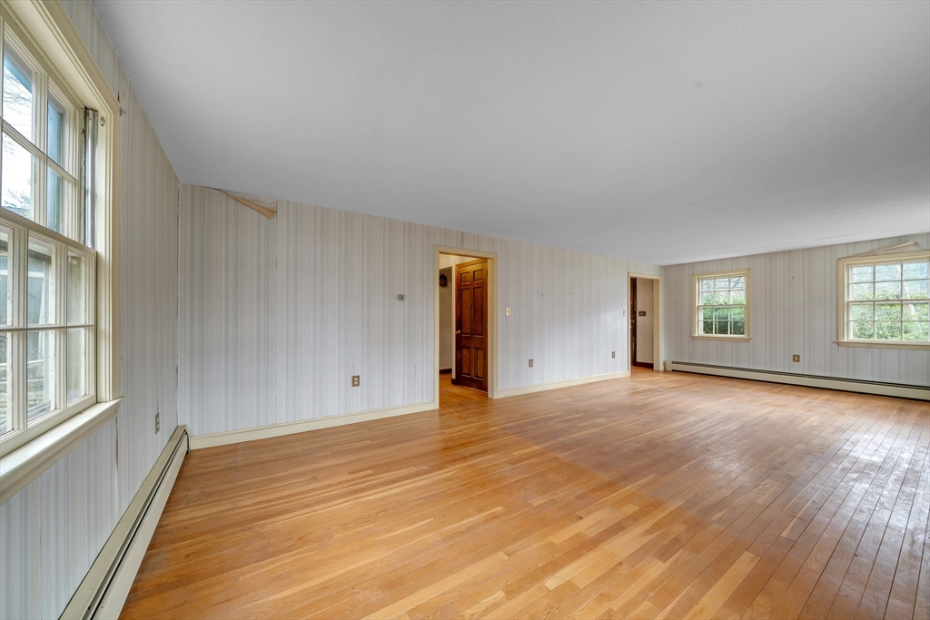 449 Summer Street North Andover, MA 01845 - Photo 2 of 26 a view of an empty room with wooden floor and windows
