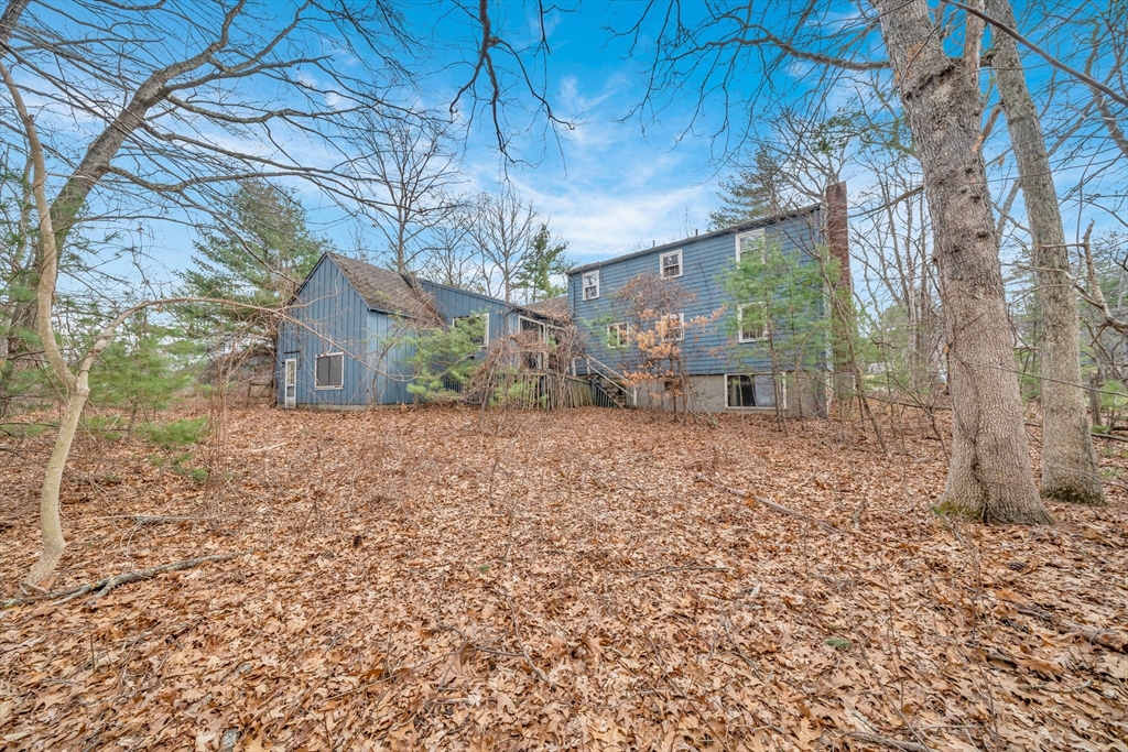 449 Summer Street North Andover, MA 01845 - Photo 21 of 26 a backyard of a house with large trees and outdoor seating