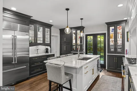 a kitchen with a stove a sink and a refrigerator