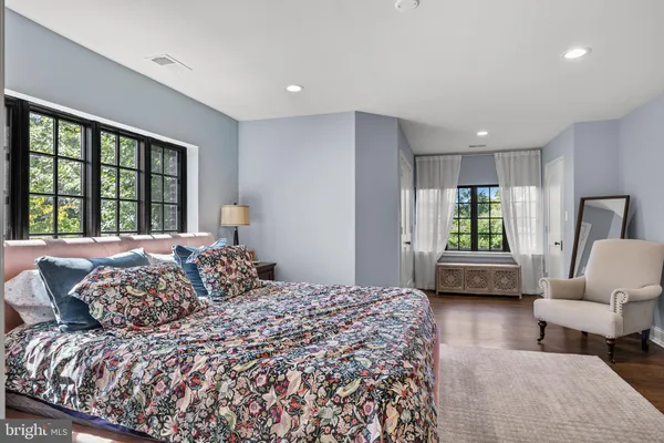 a bedroom with a bed and a couch