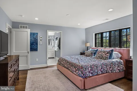 a bedroom with a large bed and a flat screen television