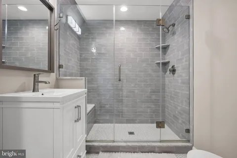 a bathroom with a shower and a sink