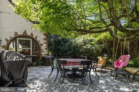 a view of a chairs and table in patio