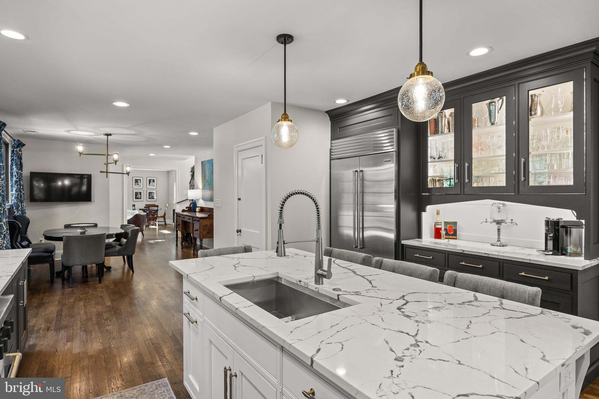 863 Golf View Road Moorestown, NJ 08057 - Photo 7 of 20 a kitchen with stainless steel appliances kitchen island granite countertop a stove a sink a oven and a dining table with wooden floor
