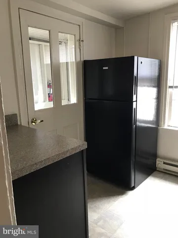 a kitchen with a refrigerator and countertop