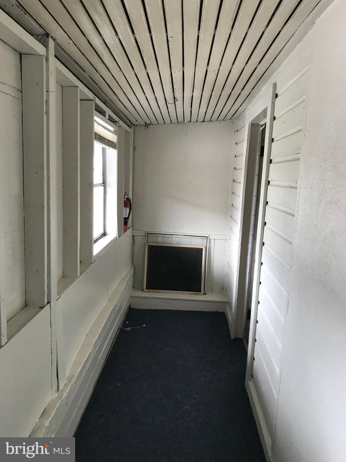244 East Patrick Street, Unit 2 Frederick, MD 21701 - Photo 18 of 18 a view of an empty room with wooden floor and a window