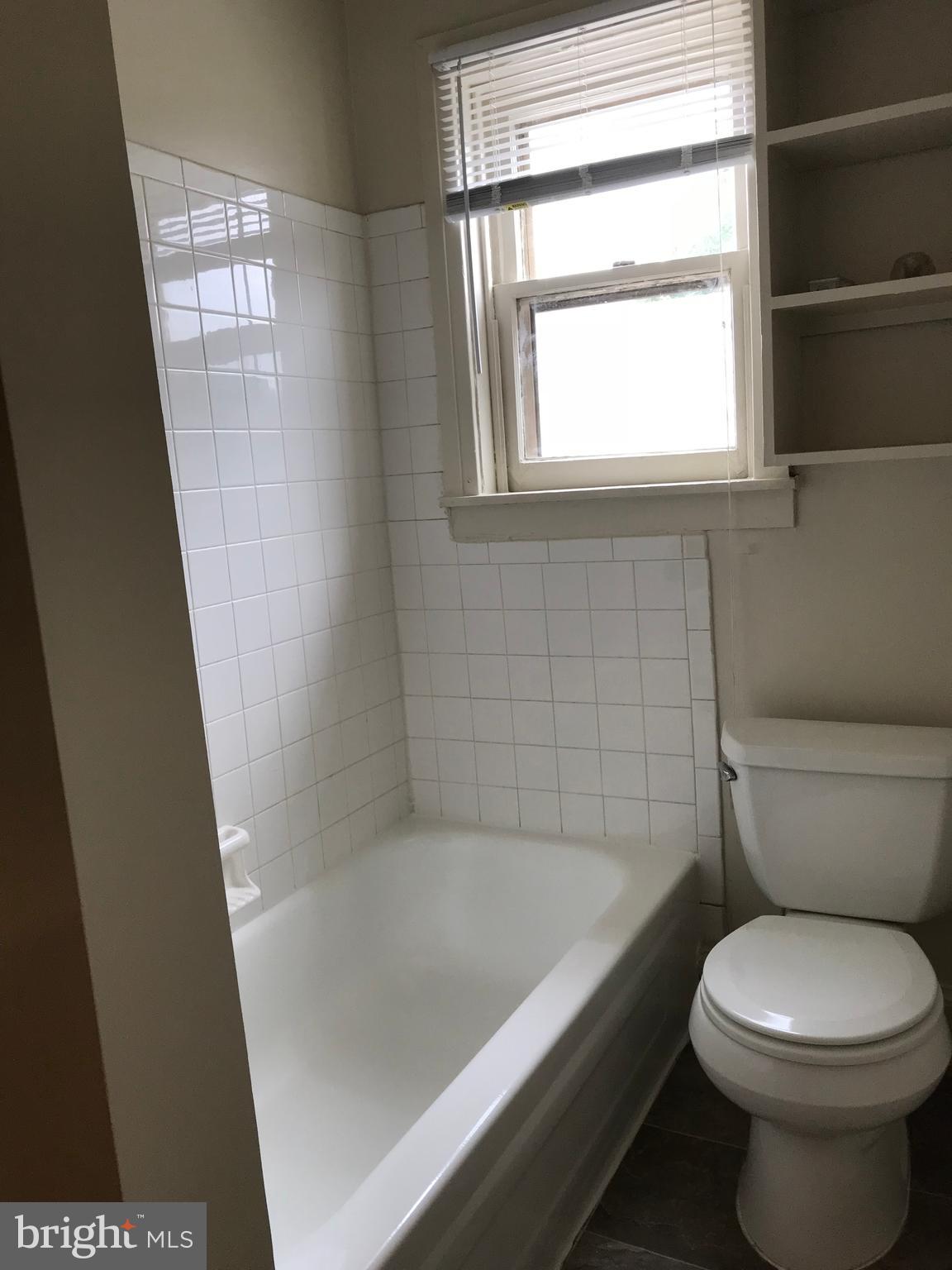 244 East Patrick Street, Unit 2 Frederick, MD 21701 - Photo 9 of 18 a bathroom with a bathtub and window