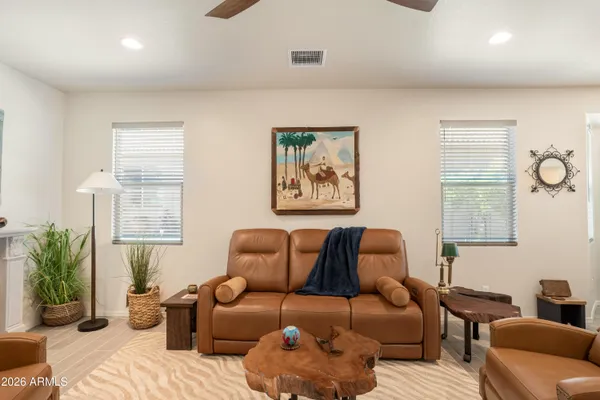 a living room with furniture chess board and a window