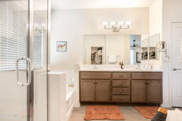 a bathroom with a double vanity sink mirror and