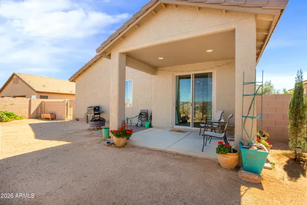 a view of the patio with dining table and chairs and potted plants