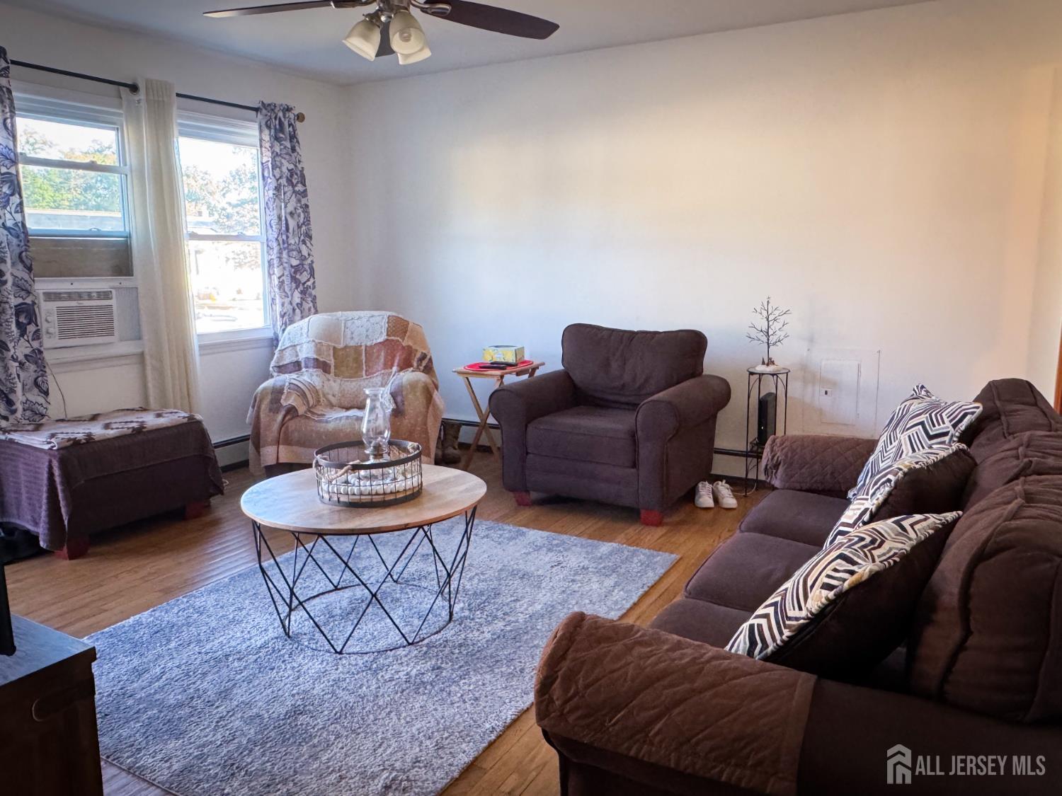 121 1st Street Middlesex, NJ 08846 - Photo 14 of 34 a living room with furniture and a rug