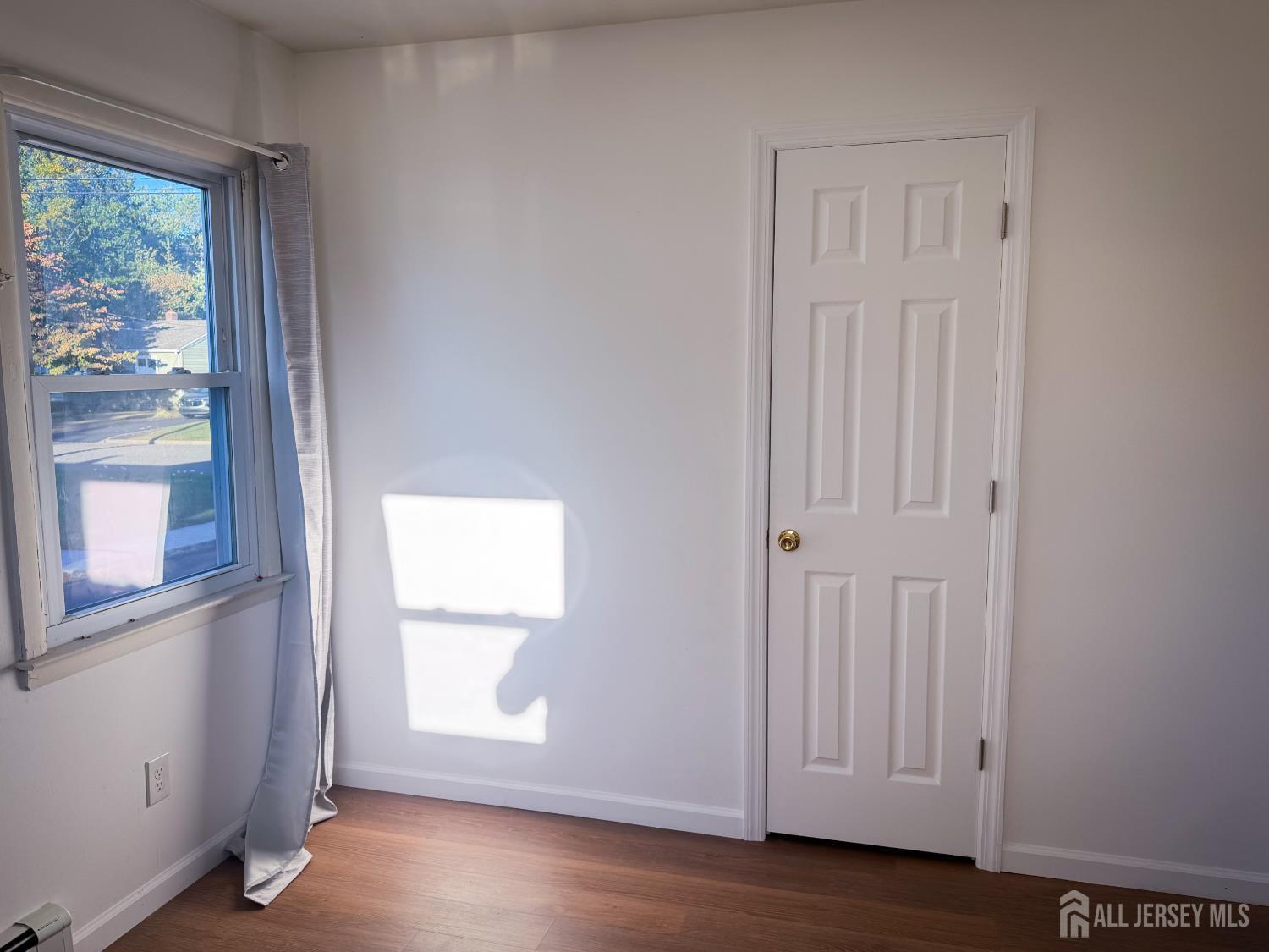 121 1st Street Middlesex, NJ 08846 - Photo 25 of 34 an empty room with wooden floor and windows