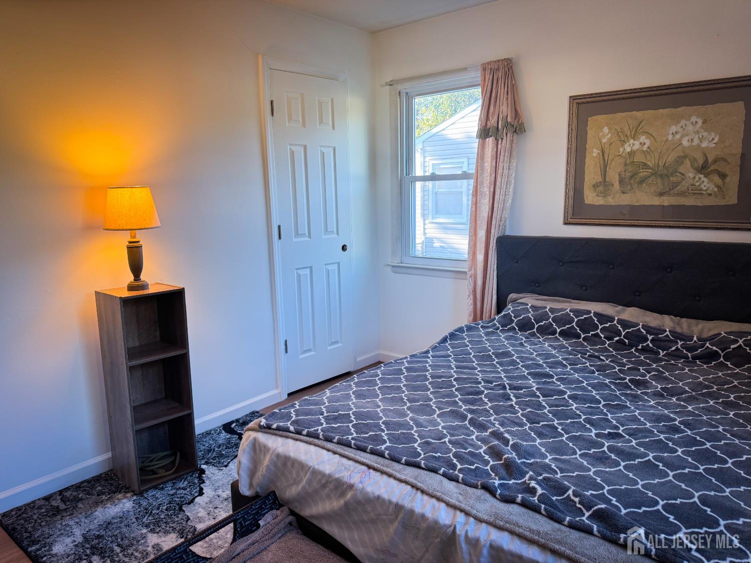 121 1st Street Middlesex, NJ 08846 - Photo 26 of 34 a bedroom with a bed and a lamp on dresser