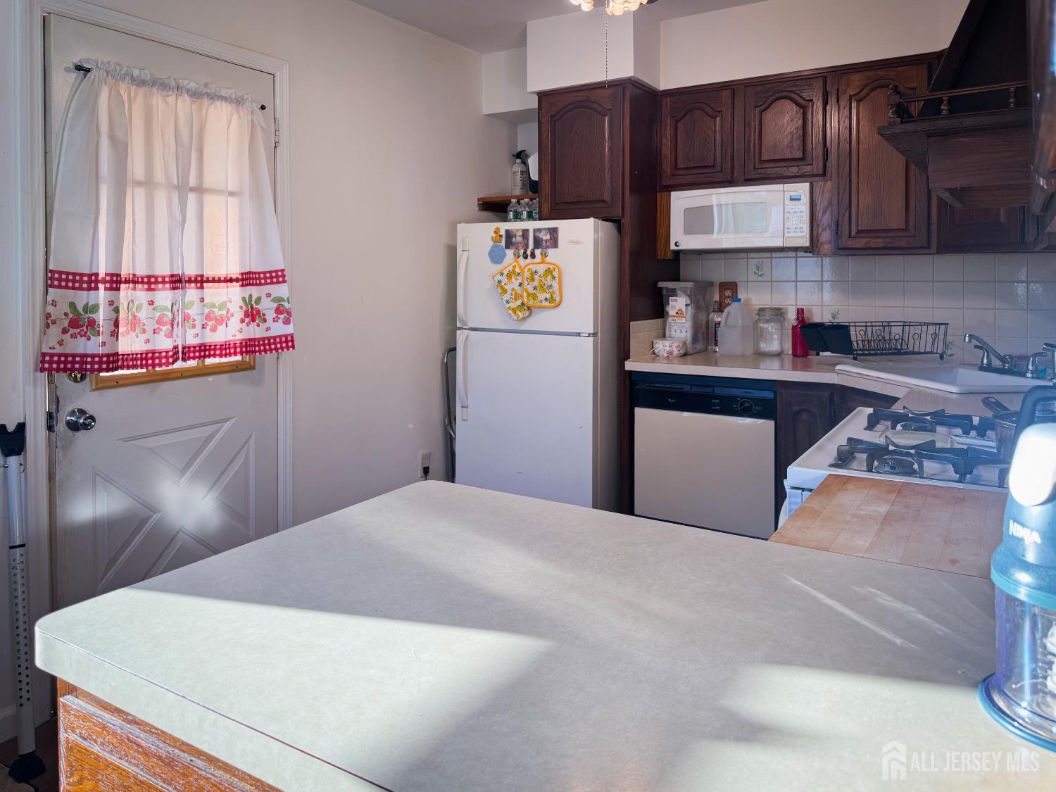 121 1st Street Middlesex, NJ 08846 - Photo 30 of 34 a kitchen with stainless steel appliances granite countertop a refrigerator sink stove and cabinets