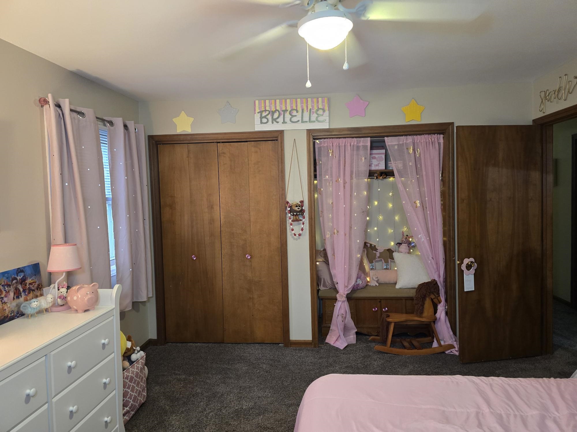 1208 Roxbury Close Rockford, IL 61107 - Photo 12 of 22 a living room with a couch and a dresser with wooden floor