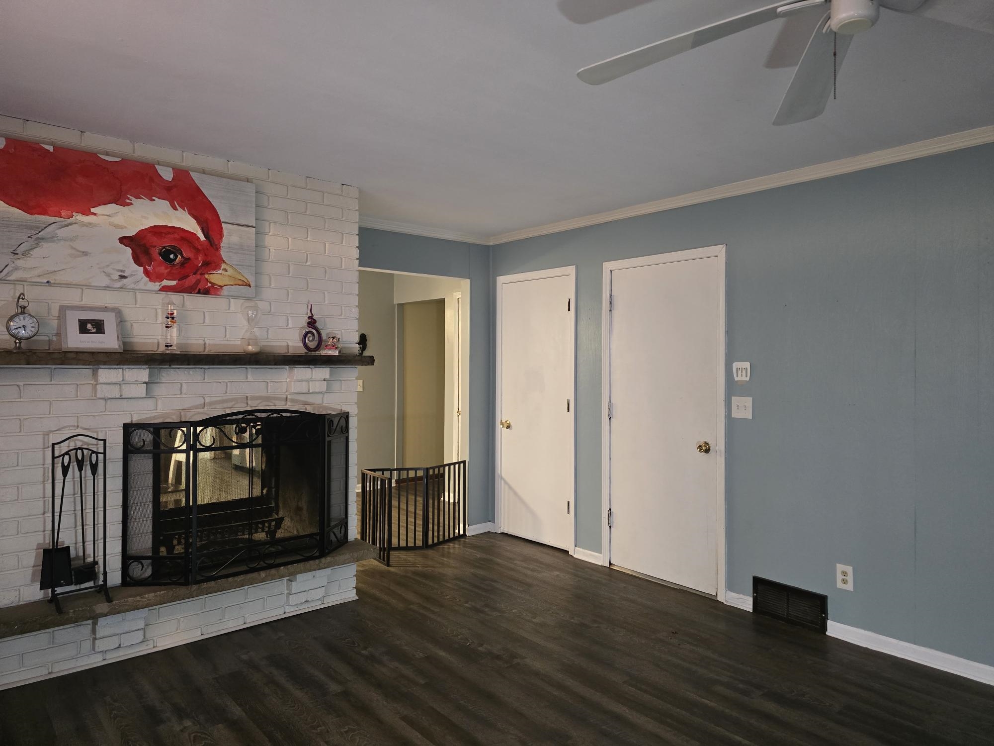 1208 Roxbury Close Rockford, IL 61107 - Photo 9 of 22 a living room with a fireplace with wooden floor