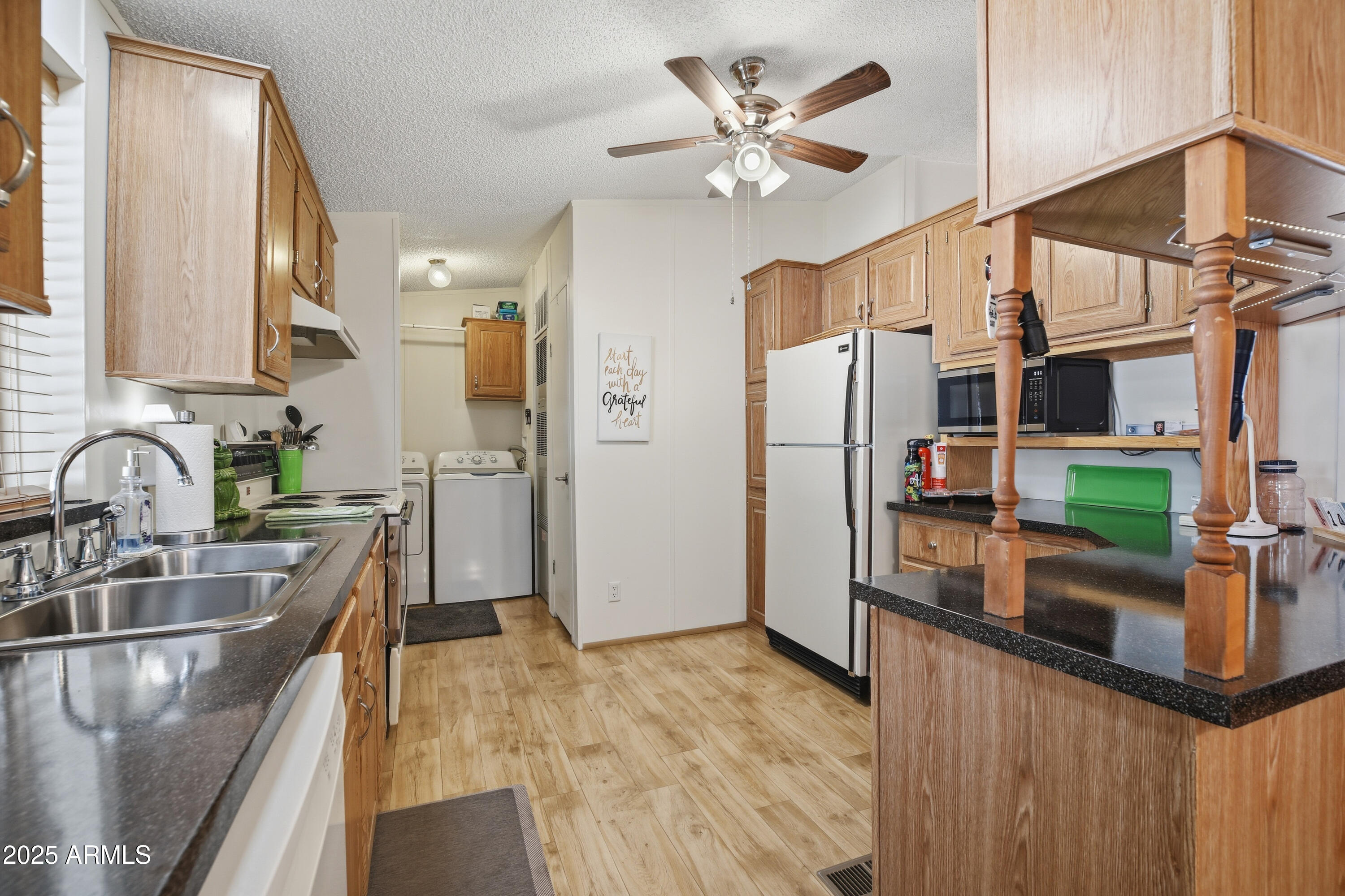 2050 West State Rte 89A, Unit 92 Sedona, AZ 86336 - Photo 11 of 34 a kitchen with stainless steel appliances granite countertop a sink a stove and a refrigerator