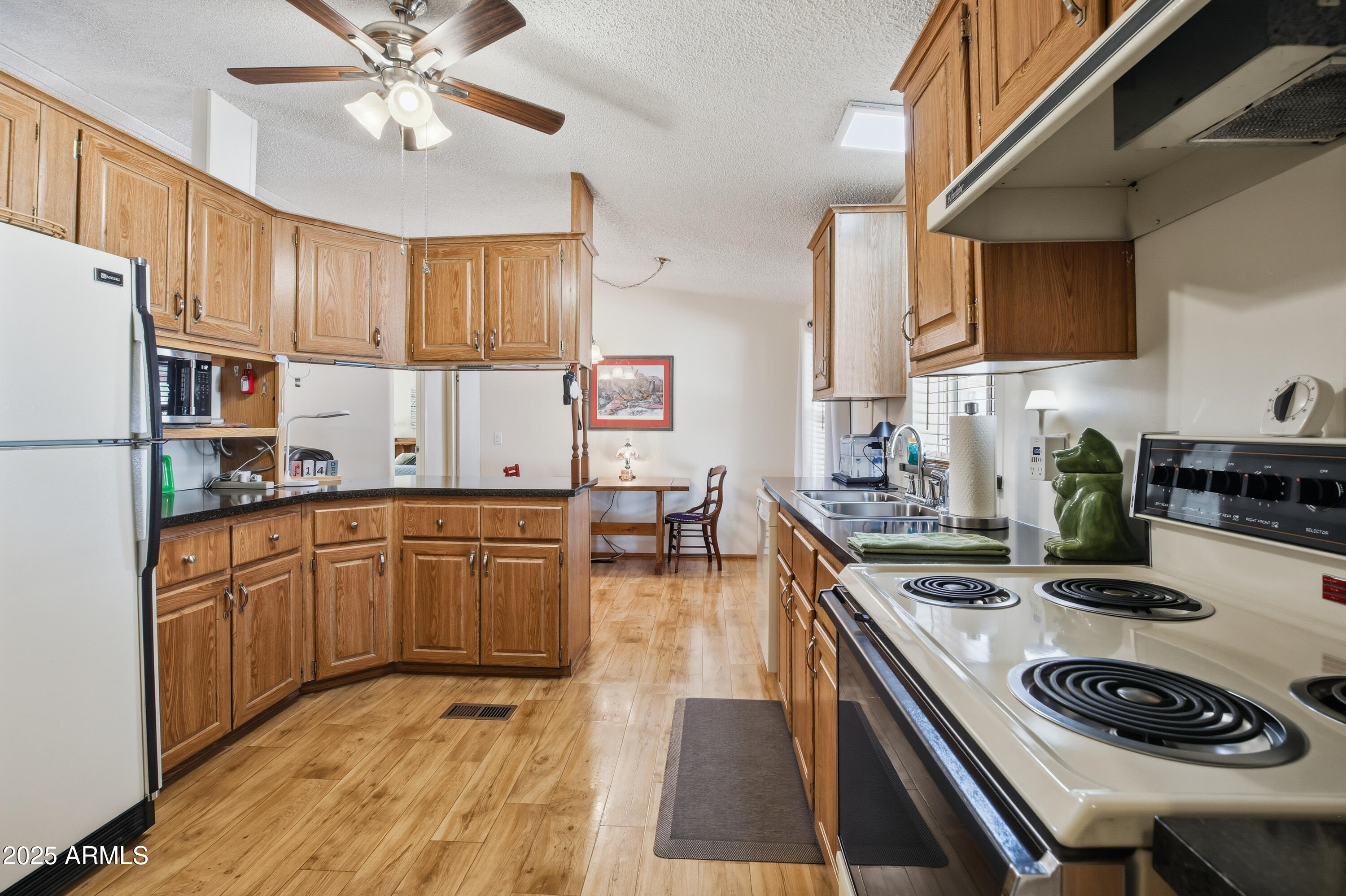 2050 West State Rte 89A, Unit 92 Sedona, AZ 86336 - Photo 12 of 34 a kitchen with stainless steel appliances granite countertop a sink stove and refrigerator