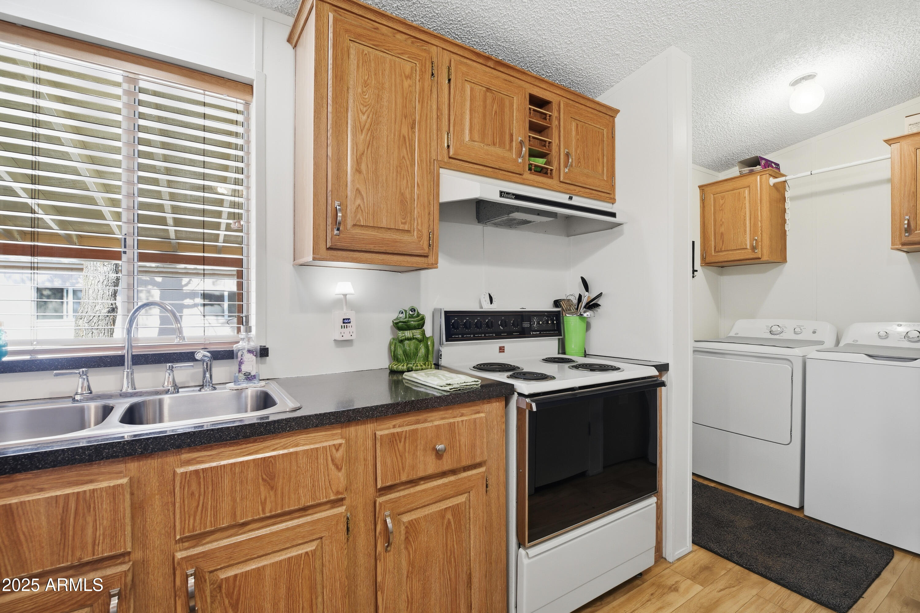 2050 West State Rte 89A, Unit 92 Sedona, AZ 86336 - Photo 14 of 34 a kitchen with stainless steel appliances granite countertop a sink a stove and cabinets