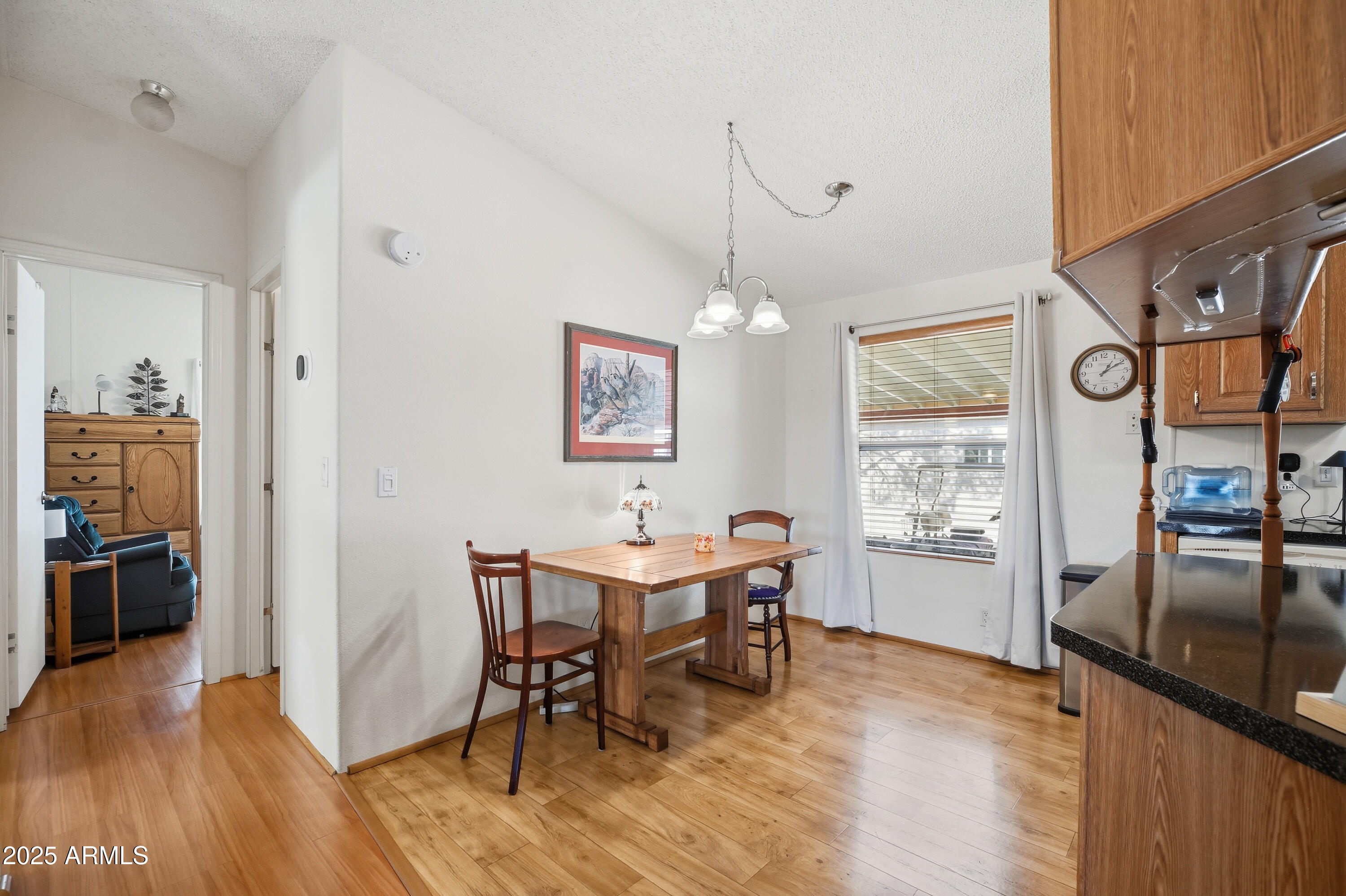 2050 West State Rte 89A, Unit 92 Sedona, AZ 86336 - Photo 16 of 34 a view of a dining room with furniture window and wooden floor