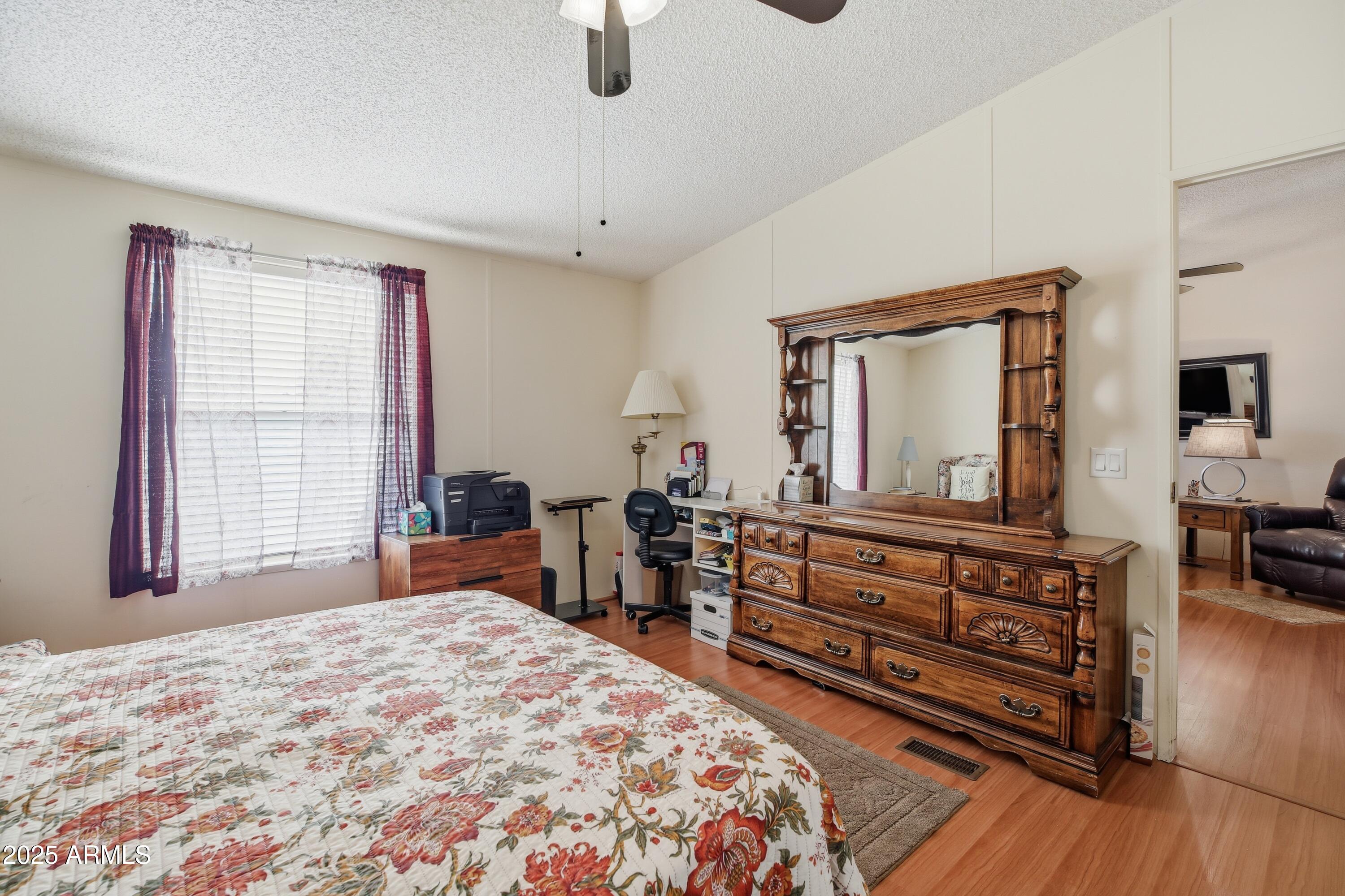2050 West State Rte 89A, Unit 92 Sedona, AZ 86336 - Photo 19 of 34 a bedroom with a bed and wooden floor