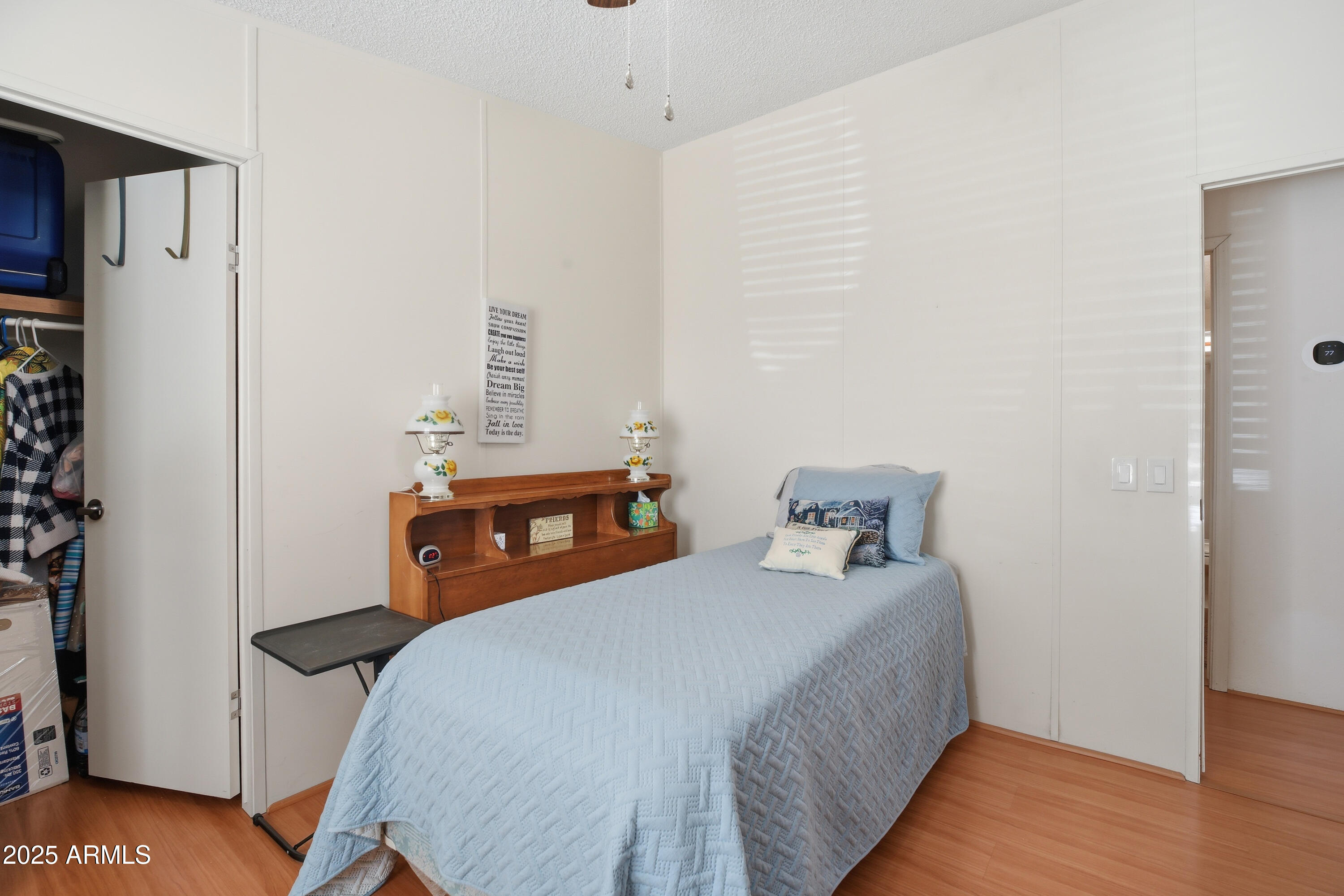 2050 West State Rte 89A, Unit 92 Sedona, AZ 86336 - Photo 26 of 34 a bedroom with a bed and wooden floor