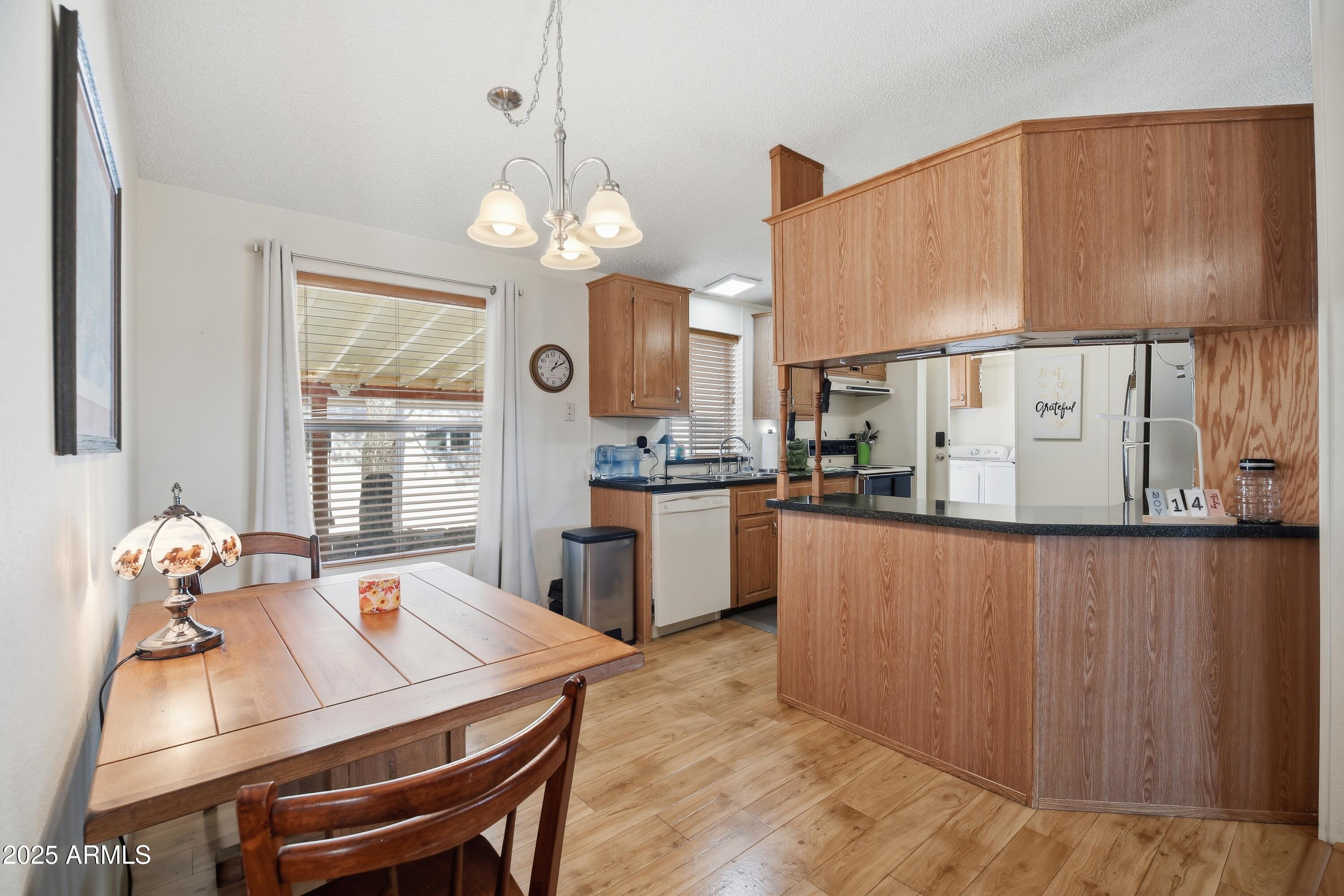 2050 West State Rte 89A, Unit 92 Sedona, AZ 86336 - Photo 9 of 34 a kitchen with granite countertop a table chairs a stove a dining table and chairs