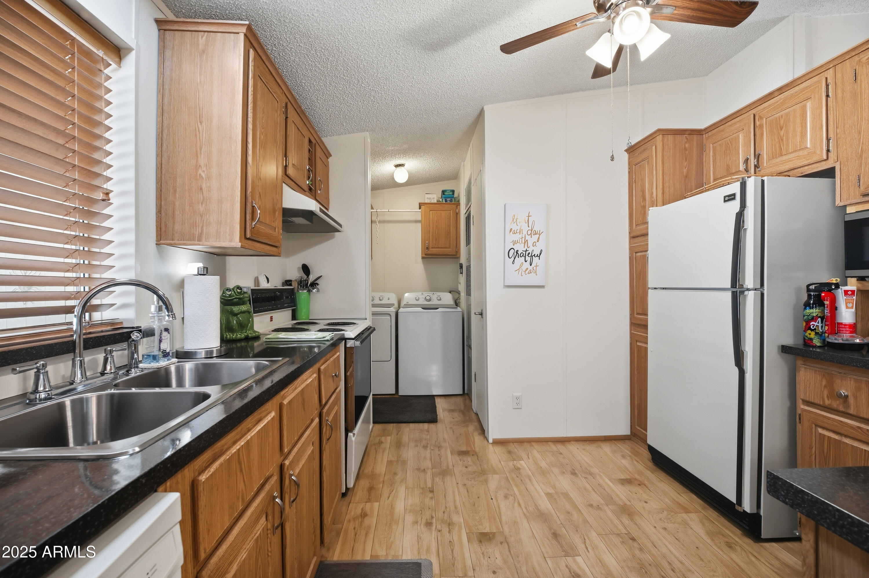 2050 West State Rte 89A, Unit 92 Sedona, AZ 86336 - Photo 10 of 34 a kitchen with a refrigerator a sink and cabinets