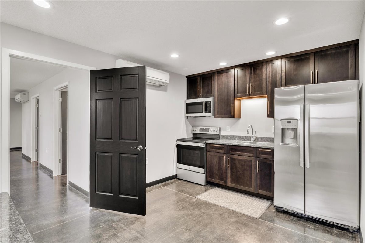 602 2nd Street West Andalusia, IL 61232 - Photo 11 of 71 a modern kitchen with stainless steel appliances kitchen island granite countertop a refrigerator and a sink