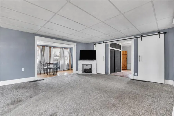 a view of a livingroom with furniture and a flat screen tv