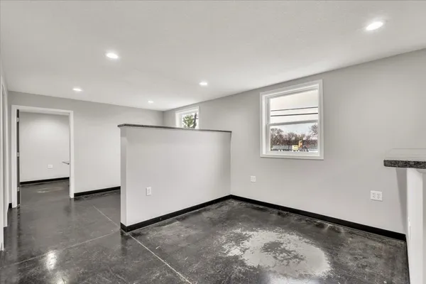 a bathroom with a granite countertop sink a toilet and a mirror