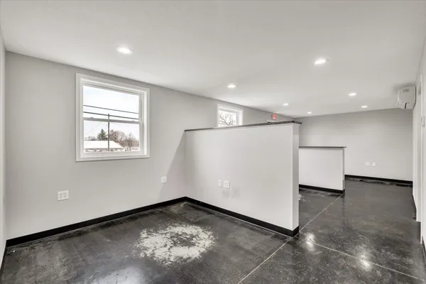 a bathroom with a granite countertop sink mirror vanity and toilet