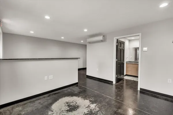 an empty room with windows and closet