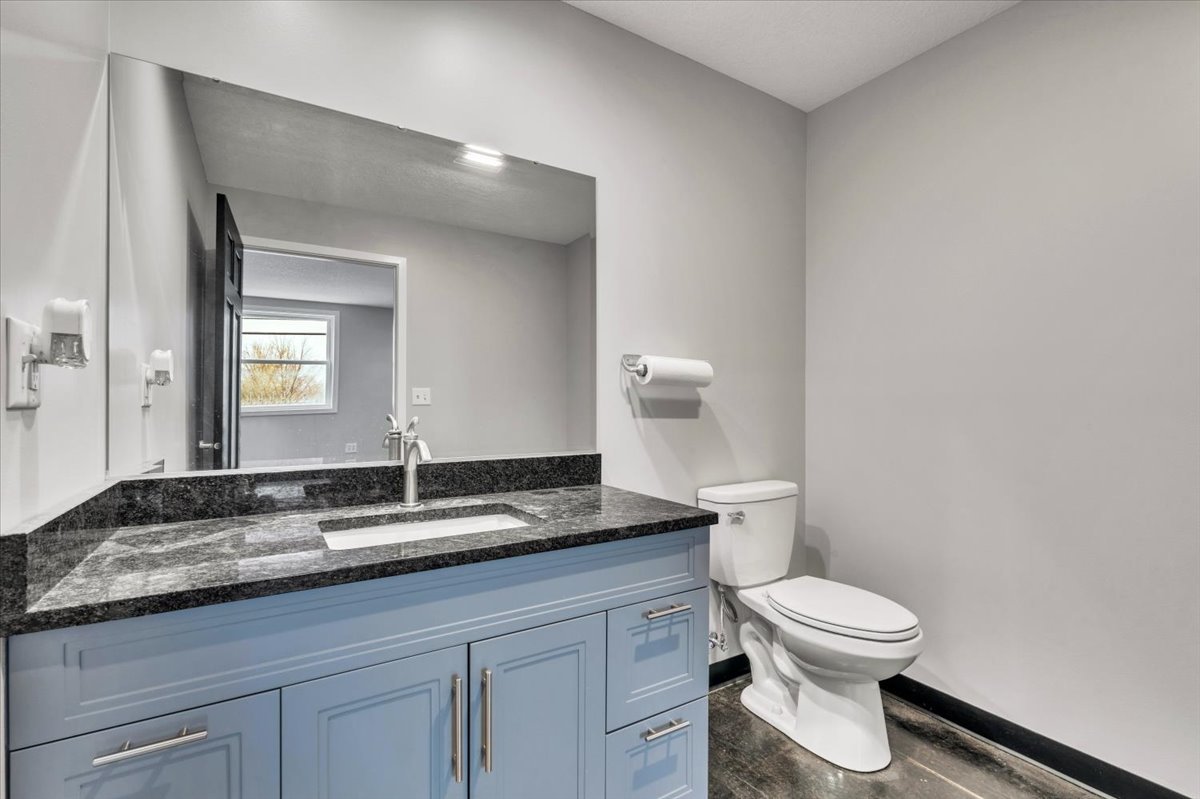 602 2nd Street West Andalusia, IL 61232 - Photo 8 of 71 a bathroom with a granite countertop sink a toilet and a mirror