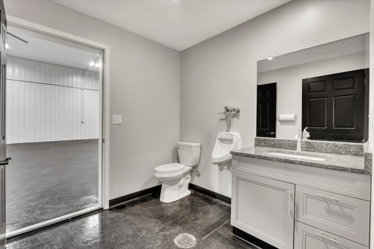 602 2nd Street West Andalusia, IL 61232 - Photo 9 of 71 a bathroom with a granite countertop sink mirror vanity and toilet