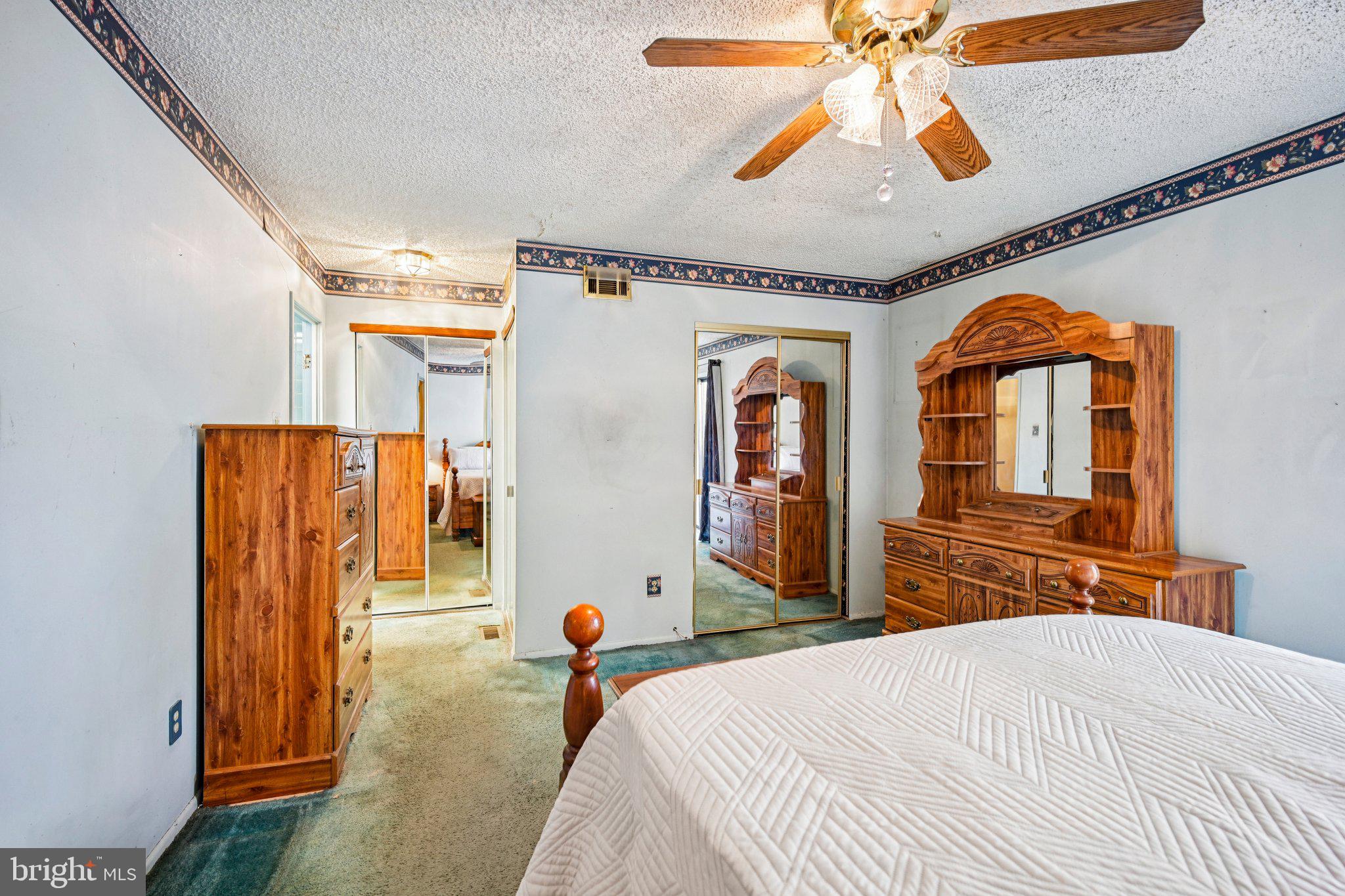 1502 Bromley Estate Pine Hill, NJ 08021 - Photo 26 of 36 a bedroom with a bed and a chandelier