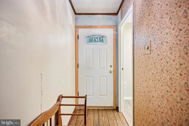 a view of front door with wooden floor