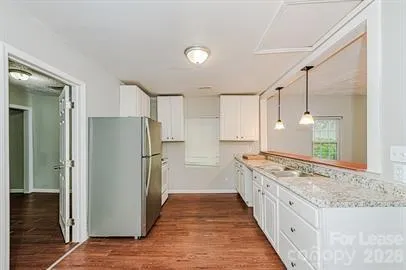 a kitchen with stainless steel appliances granite countertop a refrigerator and a sink