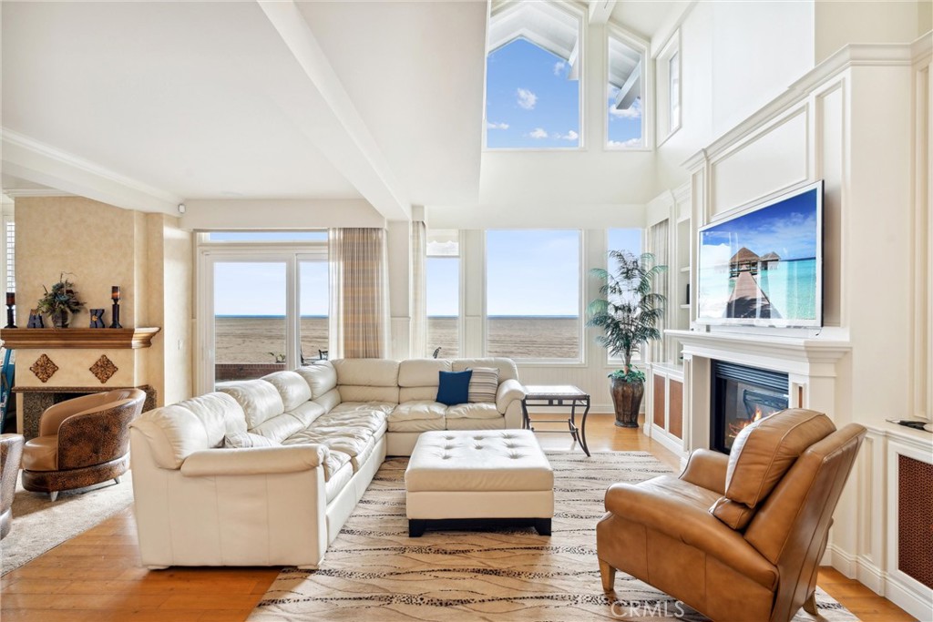 1008 West Oceanfront Newport Beach, CA 92661 - Photo 11 of 59 a living room with furniture fireplace and a large window