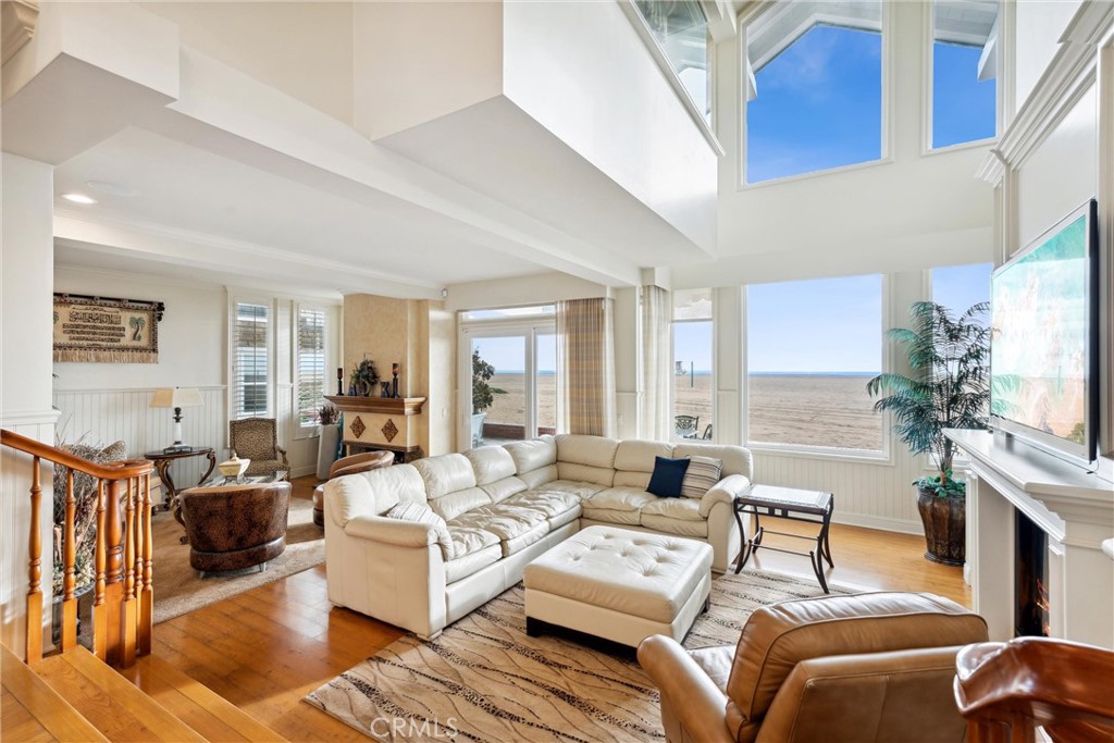 1008 West Oceanfront Newport Beach, CA 92661 - Photo 14 of 59 a living room with furniture a large window and a fireplace