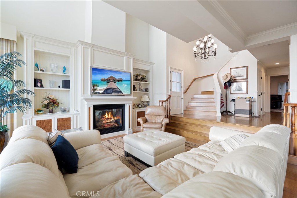 1008 West Oceanfront Newport Beach, CA 92661 - Photo 17 of 59 a living room with furniture a fireplace and a chandelier
